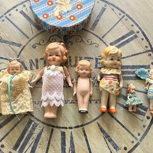Vintage Porcelain Doll Set with Lace and Floral Outfits